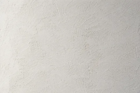 Gros plan de la texture mate d’un enduit à la chaux clair — illustration